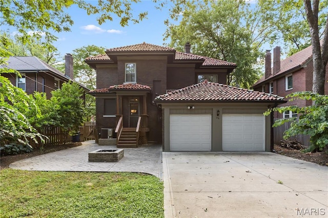316 Melville Ave, University City, MO 63130 - mediterranean / spanish home with a tile roof, concrete driveway, stucco siding, and a garage