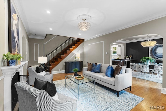 316 Melville Ave, University City, MO 63130 - living area featuring a chandelier, arched walkways, ornamental molding, light wood-style flooring, and recessed lighting