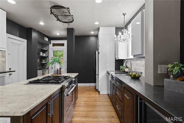 316 Melville Ave, University City, MO 63130 - kitchen with stainless steel appliances, backsplash, beverage cooler, recessed lighting, and light wood-type flooring