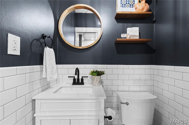 316 Melville Ave, University City, MO 63130 - bathroom with tile walls, vanity, and wainscoting