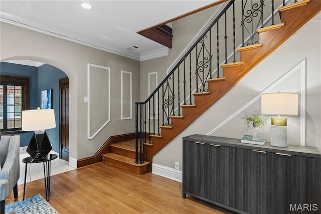 316 Melville Ave, University City, MO 63130 - stairway with arched walkways, wood finished floors, ornamental molding, and recessed lighting