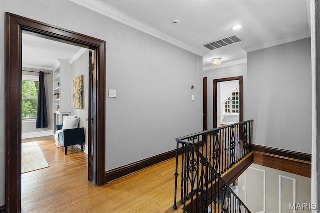 316 Melville Ave, University City, MO 63130 - corridor with an upstairs landing, light wood finished floors, and ornamental molding