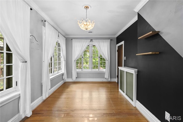 316 Melville Ave, University City, MO 63130 - unfurnished dining area featuring crown molding, a chandelier, and wood finished floors