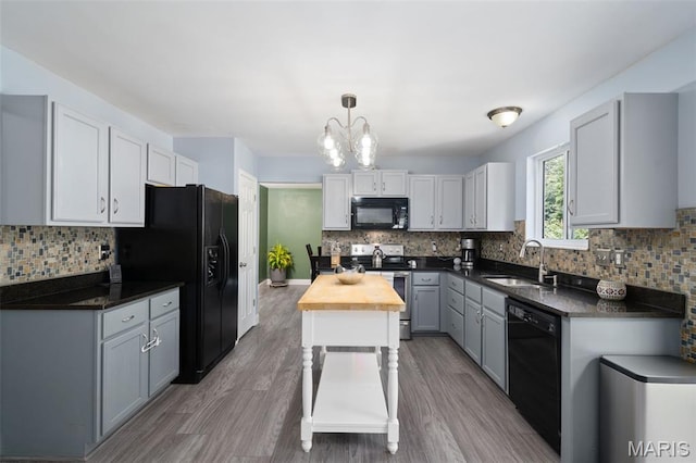 269 Sassafras Parc Dr, Ofallon, MO 63368 - kitchen featuring black appliances, wooden counters, a chandelier, and backsplash
