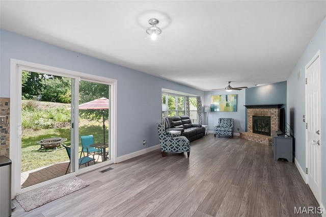 269 Sassafras Parc Dr, Ofallon, MO 63368 - living area featuring a fireplace, wood finished floors, and ceiling fan