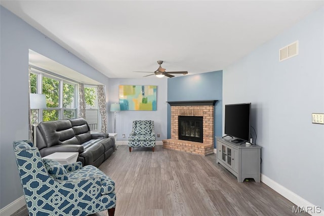 269 Sassafras Parc Dr, Ofallon, MO 63368 - living room with ceiling fan, wood finished floors, and a brick fireplace