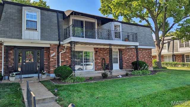 1669 Mayenne Ct Unit B, Mehlville, MO 63125 - view of front of property with a balcony, a front lawn, brick siding, a porch, and mansard roof