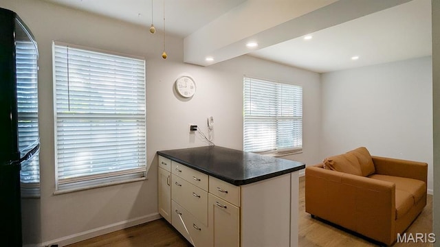 1669 Mayenne Ct Unit B, Mehlville, MO 63125 - kitchen featuring a peninsula, dark countertops, recessed lighting, black fridge, and white cabinets