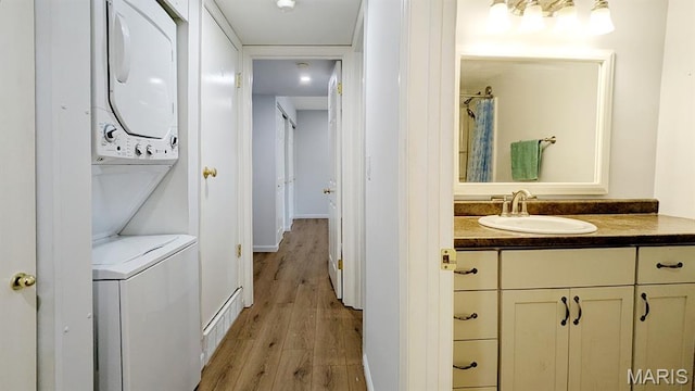 1669 Mayenne Ct Unit B, Mehlville, MO 63125 - full bath featuring stacked washing machine and dryer, wood finished floors, vanity, and a shower with curtain