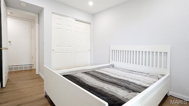 1669 Mayenne Ct Unit B, Mehlville, MO 63125 - bedroom with wood finished floors, a closet, and recessed lighting