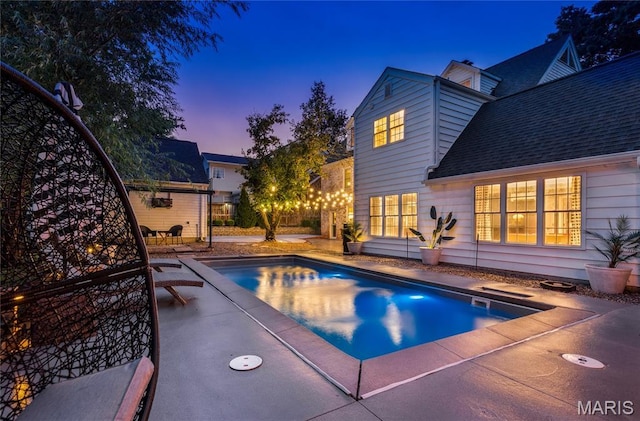 220 Orrick Ln, Kirkwood, MO 63122 - pool at dusk featuring a patio area and an outdoor pool