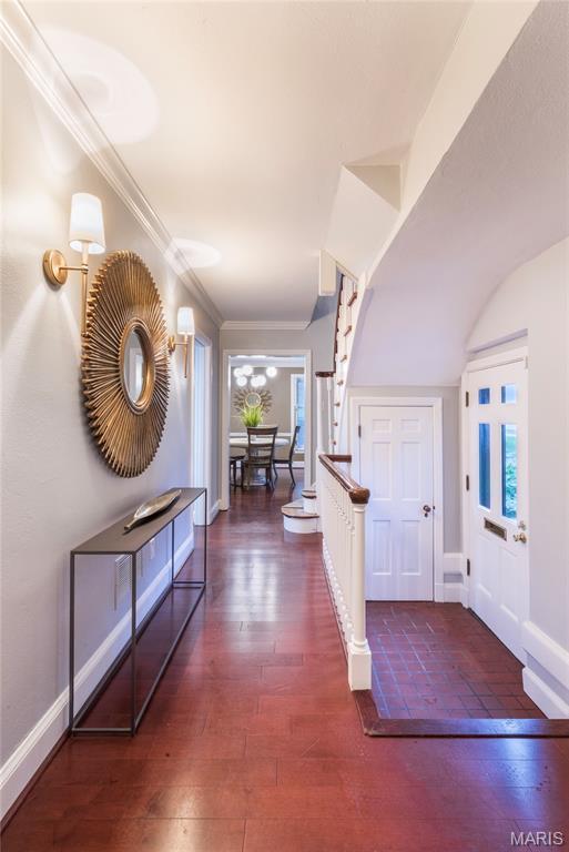 220 Orrick Ln, Kirkwood, MO 63122 - entryway featuring stairway, healthy amount of natural light, dark wood-style flooring, and crown molding
