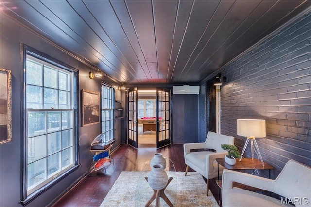220 Orrick Ln, Kirkwood, MO 63122 - sitting room featuring a wall mounted AC, wood finished floors, brick wall, plenty of natural light, and ornamental molding