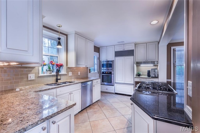 220 Orrick Ln, Kirkwood, MO 63122 - kitchen featuring built in appliances, tasteful backsplash, light stone countertops, white cabinets, and pendant lighting