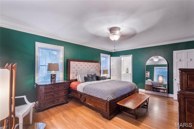 220 Orrick Ln, Kirkwood, MO 63122 - bedroom with multiple windows, light wood-type flooring, arched walkways, crown molding, and a ceiling fan