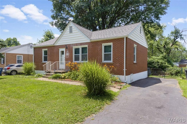 1485 E Duchesne Dr, Florissant, MO 63031 - view of front facade with brick siding, asphalt driveway, a shingled roof, and crawl space