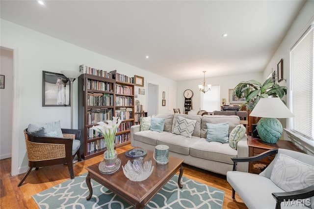1485 E Duchesne Dr, Florissant, MO 63031 - living room featuring wood finished floors, a chandelier, and recessed lighting