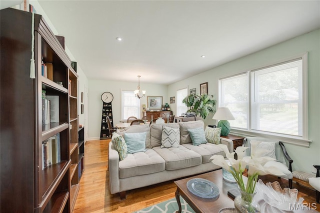 1485 E Duchesne Dr, Florissant, MO 63031 - living room featuring light wood-style floors, a chandelier, and recessed lighting