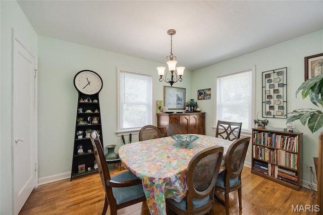 1485 E Duchesne Dr, Florissant, MO 63031 - dining space featuring a chandelier and light wood-type flooring