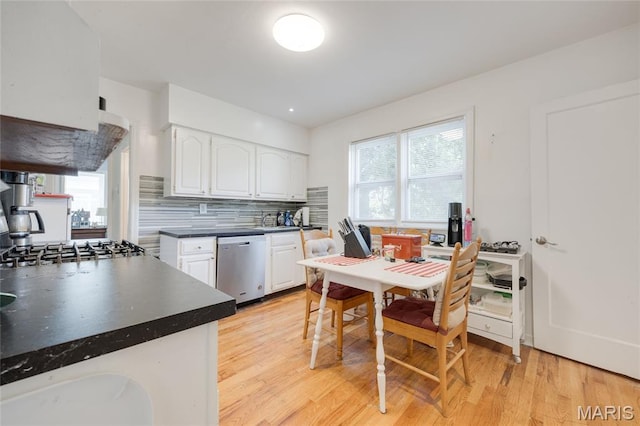 1485 E Duchesne Dr, Florissant, MO 63031 - kitchen featuring dishwasher, dark countertops, white cabinetry, and plenty of natural light