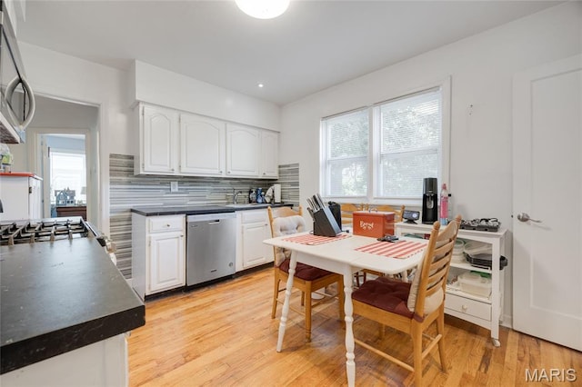 1485 E Duchesne Dr, Florissant, MO 63031 - kitchen featuring appliances with stainless steel finishes, dark countertops, white cabinets, light wood-style flooring, and recessed lighting