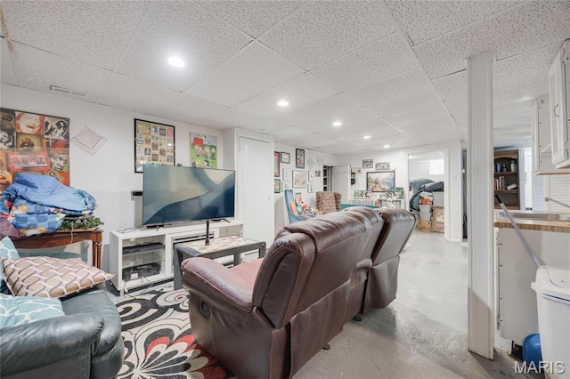 1485 E Duchesne Dr, Florissant, MO 63031 - living room featuring concrete flooring and a drop ceiling