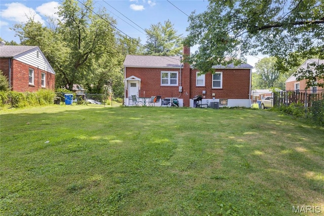 1485 E Duchesne Dr, Florissant, MO 63031 - back of property featuring a chimney and brick siding