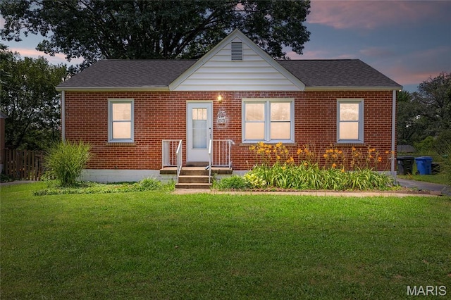 1485 E Duchesne Dr, Florissant, MO 63031 - bungalow with a yard, roof with shingles, and brick siding