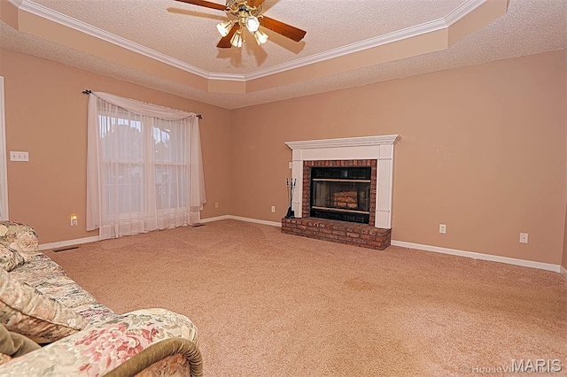 643 Woodgate St, Farmington, MO 63640 - carpeted living room featuring a textured ceiling, crown molding, a ceiling fan, and a fireplace