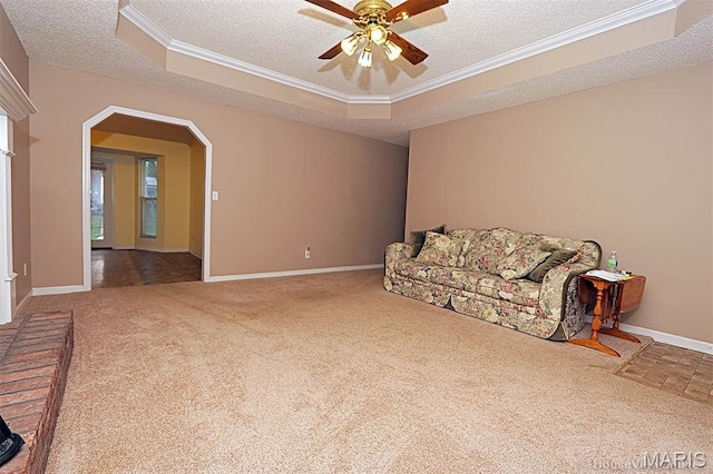 643 Woodgate St, Farmington, MO 63640 - living area with carpet flooring, a textured ceiling, ceiling fan, ornamental molding, and a tray ceiling