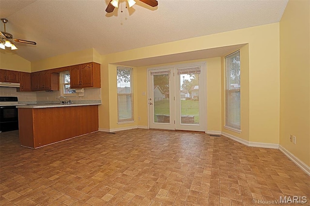 643 Woodgate St, Farmington, MO 63640 - kitchen with a ceiling fan, electric range oven, under cabinet range hood, light countertops, and a textured ceiling