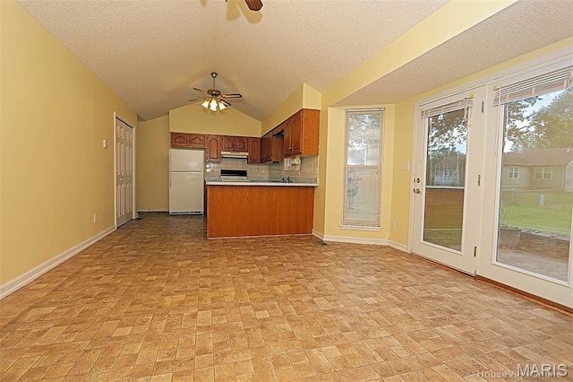 643 Woodgate St, Farmington, MO 63640 - kitchen featuring freestanding refrigerator, a ceiling fan, under cabinet range hood, brick patterned flooring, and a textured ceiling