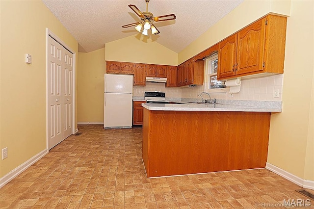 643 Woodgate St, Farmington, MO 63640 - kitchen with freestanding refrigerator, under cabinet range hood, a peninsula, brown cabinets, and backsplash