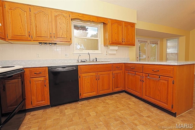 643 Woodgate St, Farmington, MO 63640 - kitchen with black dishwasher, electric range, a peninsula, light countertops, and brown cabinets