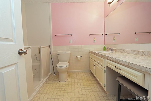 643 Woodgate St, Farmington, MO 63640 - full bath with vanity, a bath, wainscoting, tile walls, and tile patterned floors