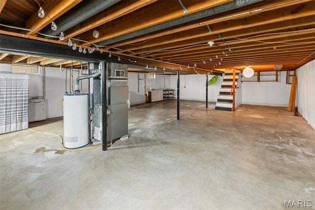 328 S Windmill St, Marine, IL 62061 - unfinished basement featuring gas water heater, heating unit, and stairway