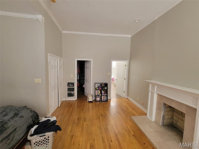 3761 Finney Ave, Saint Louis, MO 63113 - living room with crown molding, light wood-style flooring, and a tiled fireplace