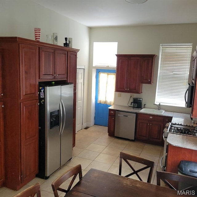 3761 Finney Ave, Saint Louis, MO 63113 - kitchen with stainless steel appliances, light tile patterned floors, healthy amount of natural light, and light countertops