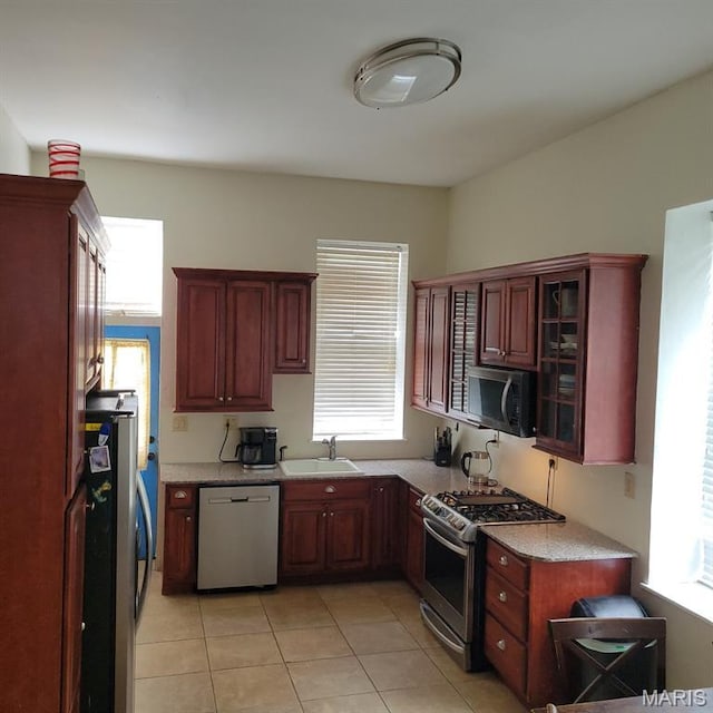 3761 Finney Ave, Saint Louis, MO 63113 - kitchen with appliances with stainless steel finishes, healthy amount of natural light, light tile patterned floors, and light countertops