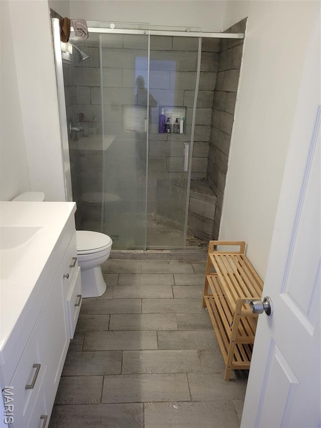 3761 Finney Ave, Saint Louis, MO 63113 - full bath featuring vanity, a shower stall, and wood tiled floors