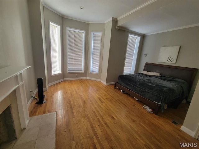 3761 Finney Ave, Saint Louis, MO 63113 - bedroom featuring light wood finished floors, ornamental molding, and a premium fireplace