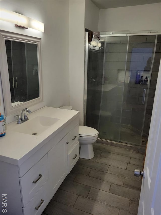 3761 Finney Ave, Saint Louis, MO 63113 - bathroom featuring vanity, a shower stall, and wood finish floors