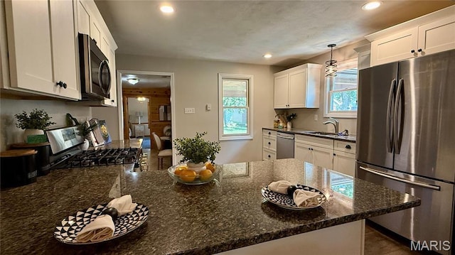 504 N Moore St, Waterloo, IL 62298 - kitchen featuring appliances with stainless steel finishes, recessed lighting, white cabinets, dark stone counters, and decorative light fixtures