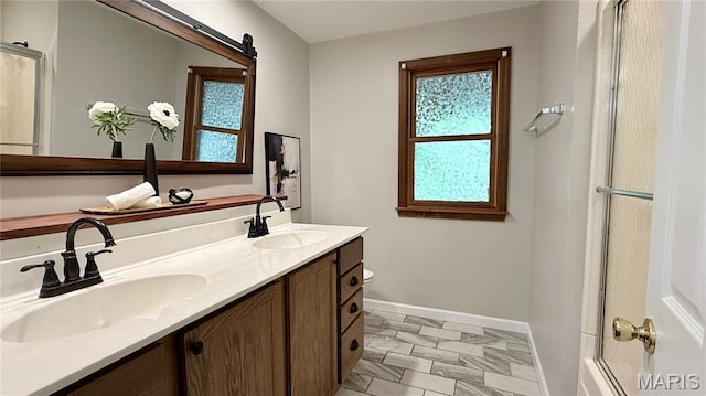 504 N Moore St, Waterloo, IL 62298 - bathroom featuring baseboards and double vanity