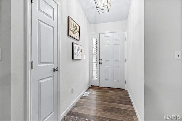 1941 Magnolia Way, Pevely, MO 63070 - doorway to outside with dark wood-style floors, a textured wall, and a chandelier
