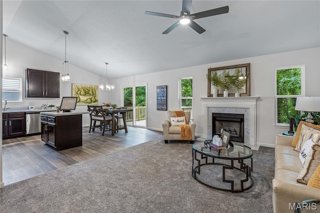 1941 Magnolia Way, Pevely, MO 63070 - living area with lofted ceiling, a chandelier, a fireplace, a ceiling fan, and carpet