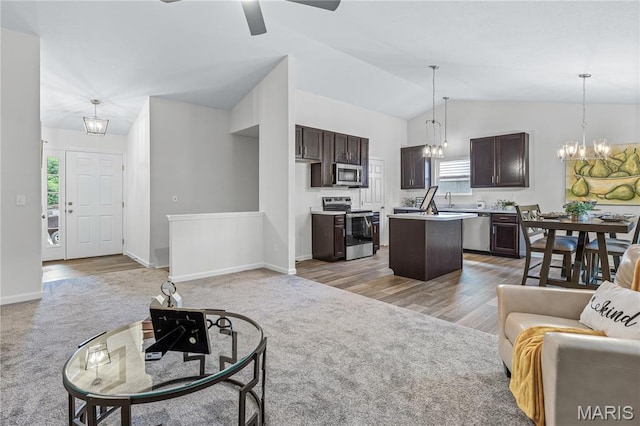 1941 Magnolia Way, Pevely, MO 63070 - living room featuring light colored carpet, a chandelier, vaulted ceiling, ceiling fan, and plenty of natural light