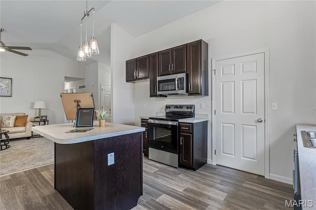 1941 Magnolia Way, Pevely, MO 63070 - kitchen featuring stainless steel appliances, ceiling fan, wood finished floors, open floor plan, and dark brown cabinets