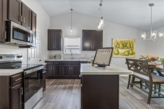 1941 Magnolia Way, Pevely, MO 63070 - kitchen with appliances with stainless steel finishes, lofted ceiling, light countertops, dark brown cabinets, and dark wood-style flooring