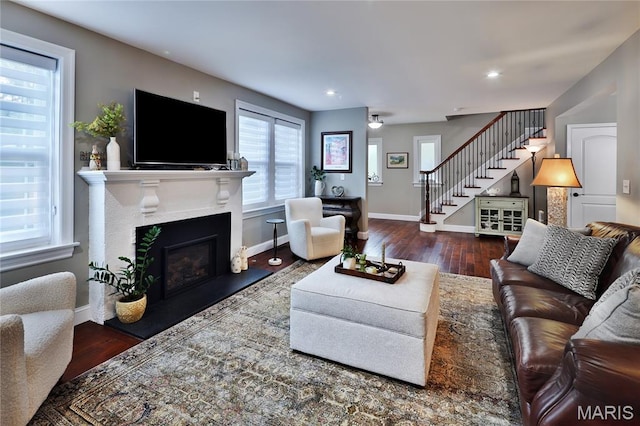 728 Yale Ave, Saint Louis, MO 63130 - living room featuring stairway, wood finished floors, a glass covered fireplace, and recessed lighting